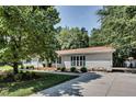 Well-maintained house featuring lush trees, a driveway, and tasteful landscaping at 835 Pearleman Teague Rd, Siler City, NC 27344