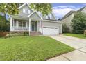 Attractive home with lush lawn, charming porch, and two-car garage, ideal for comfortable suburban living at 853 Bluffcreek Dr, Fuquay Varina, NC 27526
