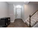 Elegant foyer with hardwood floors, staircase, and stylish decor at 9 Moss Side Ter, Durham, NC 27703