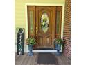 Inviting front door with decorative wreath and potted plants adding charm to the entrance at 100 Deer Ridge Rd, Siler City, NC 27344