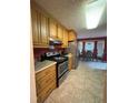 Functional kitchen with stainless steel appliances and adjacent dining area at 100 Deer Ridge Rd, Siler City, NC 27344