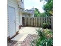 Cozy back patio with partial privacy fence and small, landscaped yard at 106 Knight Ct, Graham, NC 27253