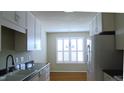 Bright eat-in kitchen with white cabinetry and stainless steel appliances at 106 Knight Ct, Graham, NC 27253