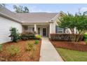 Charming covered entrance with lush landscaping, leading to the front door at 1104 Gaston Manor Dr, Durham, NC 27703