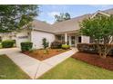 Inviting walkway leading to the front door surrounded by lush landscaping and mulch at 1104 Gaston Manor Dr, Durham, NC 27703