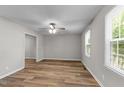 Cozy bedroom featuring durable floors, neutral paint, and bright window at 113 Fox Run, Henderson, NC 27536