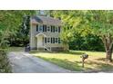 View of the front yard featuring a lush green lawn and a charming mailbox at 113 Fox Run, Henderson, NC 27536