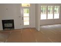 Bright living room featuring a fireplace, bright windows, and a door to the outdoor area at 1155 Shonele Ln, Stem, NC 27581