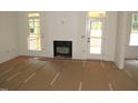 Spacious living room featuring a fireplace, bright windows, and a door to the outdoor area at 1155 Shonele Ln, Stem, NC 27581
