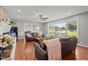 Cozy living room with hardwood floors, a fireplace, and lots of natural light at 12082 Nc 42, Fuquay Varina, NC 27526