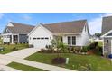 Beautiful front exterior with a well-manicured lawn, featuring a lush tree, and a white garage door at 1319 Richfield Oaks Dr, Fuquay Varina, NC 27526
