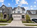 Charming two-story home with a well-manicured lawn and an attached two-car garage at 140 Big Barn Dr, Wendell, NC 27591