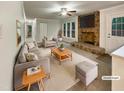 Bright living room with stone fireplace, plush seating, and neutral decor. Virtually staged at 1508 Hodge Rd, Knightdale, NC 27545