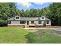 Well-maintained single-story home with a welcoming front deck, perfect for relaxing outdoors in a green yard at 160 Deer Tracks Dr, Wendell, NC 27591