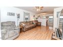 Cozy living room with hardwood floors, ceiling fan, and ample natural light at 1605 Goldsboro Ave, Sanford, NC 27330