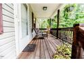 Inviting front porch with chairs and plants creating a welcoming outdoor space to relax at 1605 Goldsboro Ave, Sanford, NC 27330