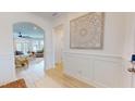 Bright foyer with archway, decorative wall art, and hardwood floors leading to living area at 1720 Pinecliff Ct, Fuquay Varina, NC 27526