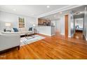 Bright living room with hardwood floors, neutral paint, and an open flow to the kitchen at 1825 Watkins St, Raleigh, NC 27604