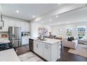 Open kitchen featuring stainless appliances, a central island, and views to the living area at 2019 Nebula Way, Durham, NC 27703