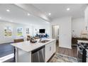 Bright open kitchen with a large island, stainless steel appliances, and modern finishes at 2019 Nebula Way, Durham, NC 27703