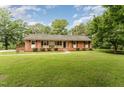 Inviting single-story home with lush front yard and covered porch, perfect for relaxing at 2139 Race Track Rd, Burlington, NC 27215