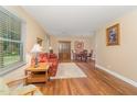 Cozy living room with hardwood floors, patterned sofa, and natural light, transitioning into dining area at 2139 Race Track Rd, Burlington, NC 27215