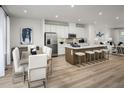 Bright, open concept kitchen with stainless steel appliances, center island, and breakfast bar seating at 2348 Stephens Pass Sta, Apex, NC 27502
