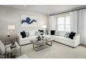 Well-lit living room with neutral color palette and plush seating creating an inviting and comfortable space at 2348 Stephens Pass Sta, Apex, NC 27502