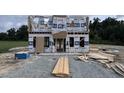 New home construction featuring framed walls, windows, and roof, with protective wrap covering at 242 Waterwheel Dr, Selma, NC 27576