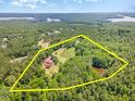 This aerial shot of a lakeside property highlights its expansive lot, wooded privacy and surrounding lake views at 2540 Seaforth Rd, Pittsboro, NC 27312