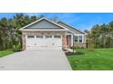 Beautiful home with a two-car garage, stone accents, and a well-manicured lawn at 28 Elmwood Ave, Sanford, NC 27330