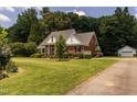 Traditional brick home with an attached garage and a neatly maintained lawn at 2819 Russell Mcpherson Rd, Burlington, NC 27215