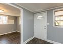 View of the interior front door and entrance featuring wood-look floors and gray painted walls at 3013 Avery St, Raleigh, NC 27610