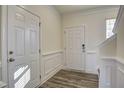 Bright foyer with hardwood floors, wainscotting, and classic trim at 3505 Triad Ct, Raleigh, NC 27604
