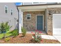 Inviting front porch with brick accents and landscaping at 3505 Triad Ct, Raleigh, NC 27604