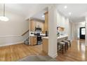 Open-concept kitchen featuring stainless steel appliances and a breakfast bar with seating at 4211 Norman Ridge Ln, Raleigh, NC 27613