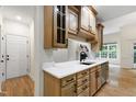 Well-lit kitchen featuring stylish countertops, wood cabinetry, and stainless steel appliances at 4211 Norman Ridge Ln, Raleigh, NC 27613