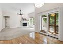 Bright living room featuring a marble fireplace, a ceiling fan, and a sliding glass door to the deck at 4211 Norman Ridge Ln, Raleigh, NC 27613