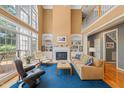 Bright living room boasts soaring ceilings, a fireplace with built-ins, and large windows that flood the space with natural light at 4613 Moores Creek Rd, Durham, NC 27705