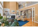 Open-concept living room with fireplace and built-ins, offering comfortable seating and a view of the second-floor balcony at 4613 Moores Creek Rd, Durham, NC 27705