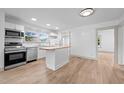 Modern kitchen featuring stainless steel appliances, white cabinets, and butcher block island at 502 S Eighth St, Mebane, NC 27302