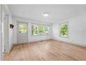 Bright living room with natural light and updated floors and new door and window trim at 502 S Eighth St, Mebane, NC 27302