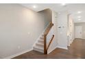 Inviting foyer featuring hardwood floors, a staircase with wooden banister and neutral paint at 513 Brooks St, Wake Forest, NC 27587