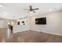 Open concept living room with hardwood floors, ceiling fan and views of the kitchen at 513 Brooks St, Wake Forest, NC 27587