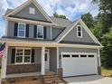 Charming two-story home with gray siding, black shutters, and a spacious white two-car garage at 5905 Genesee Dr., Homesite 6, Durham, NC 27712