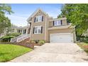 A charming two-story home featuring a front-entry garage, complemented by lush lawn at 613 Penncross Dr, Raleigh, NC 27610