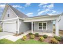 Charming single-Gathering home with a gray exterior, attached garage, and well-manicured lawn at 66 W Emily Gardens Dr, Selma, NC 27576