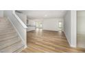 Open concept living space with abundant natural light and beautiful wood flooring throughout at 66 W Emily Gardens Dr, Selma, NC 27576