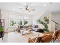 Bright living room with a comfortable sofa, ceiling fan, and neutral decor at 6928 Leesville Rd, Raleigh, NC 27613