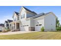 Spacious home featuring a two-car garage and a well-maintained lawn, offering both convenience and beauty at 713 Ramsours Mill Dr, Holly Springs, NC 27540